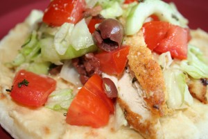 Falafel Crusted Chicken Pita Falafel crusted chicken breast grilled and served on a warm pita