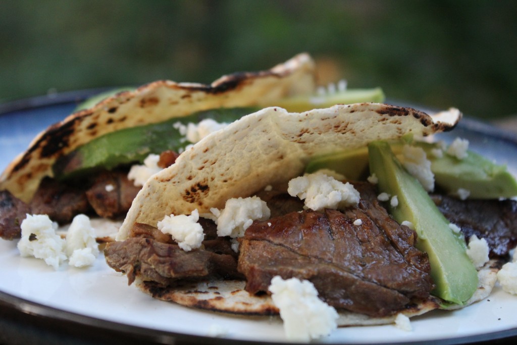 tender carne asada tacos with cotija cheese, avocado and lime